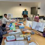 People taking part in an art group designing 'Open Surprise Books'.