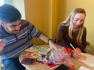 Photo of Hamza and his 'Buddy' enjoying a crafternoon session. Hamza recently graduated from BuddyUp which you can read about in our February newsletter.